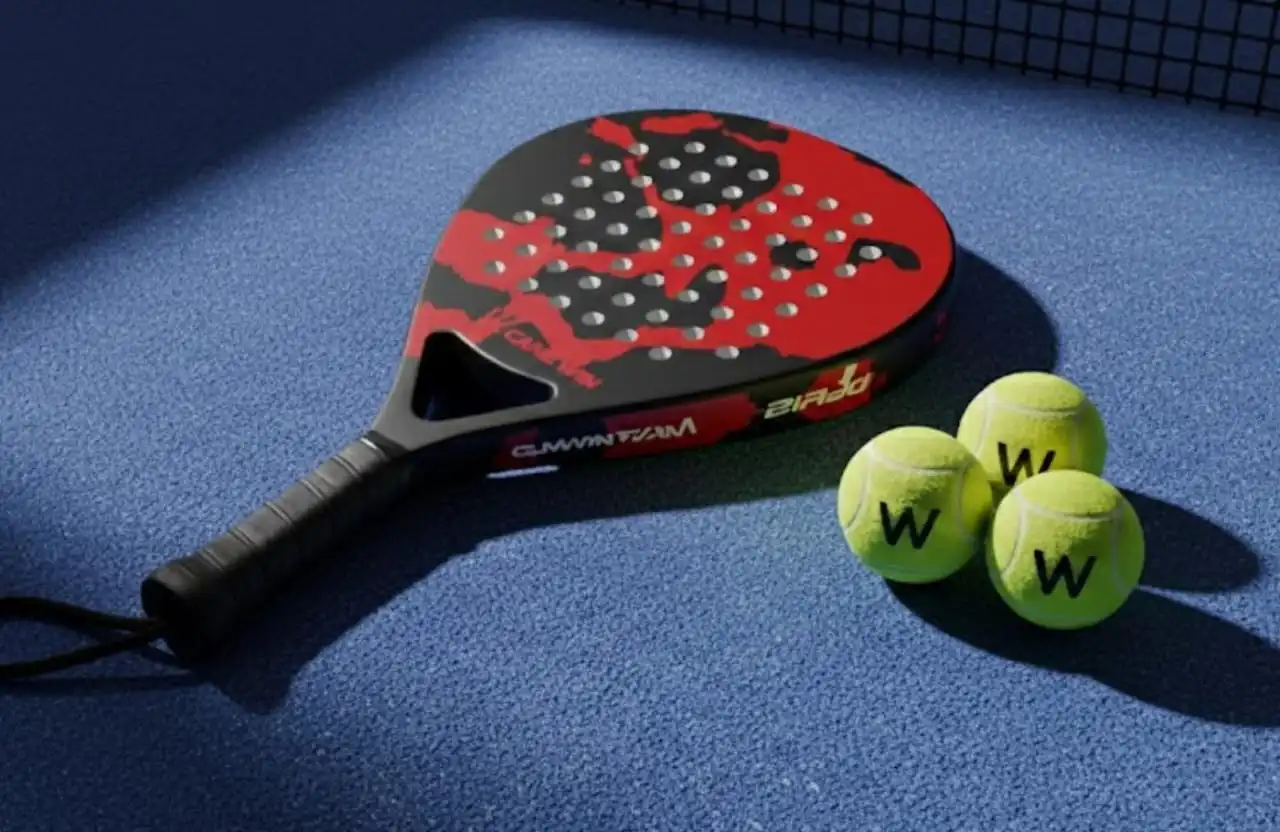 Black and red Camewin padel racket with balls on a blue surface.