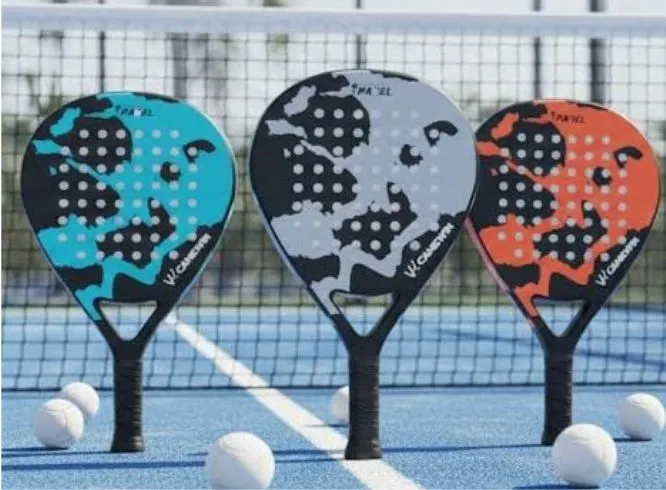 Three Camewin carbon fiber Padel rackets in blue, white, and orange on an outdoor court.